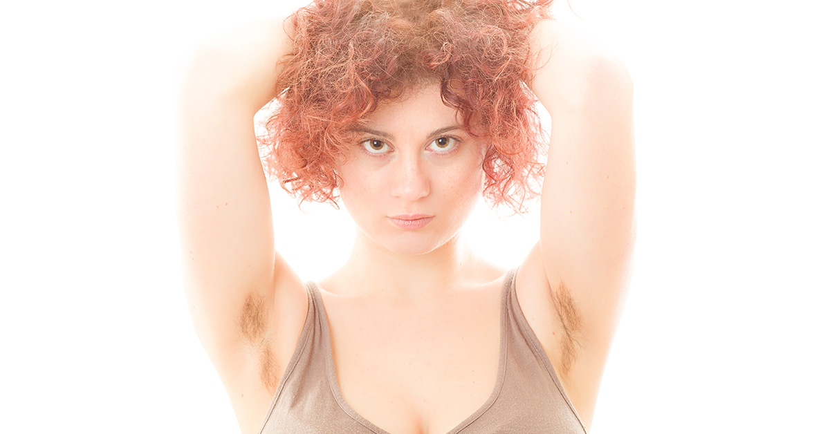 red haired woman showing armpit hair
