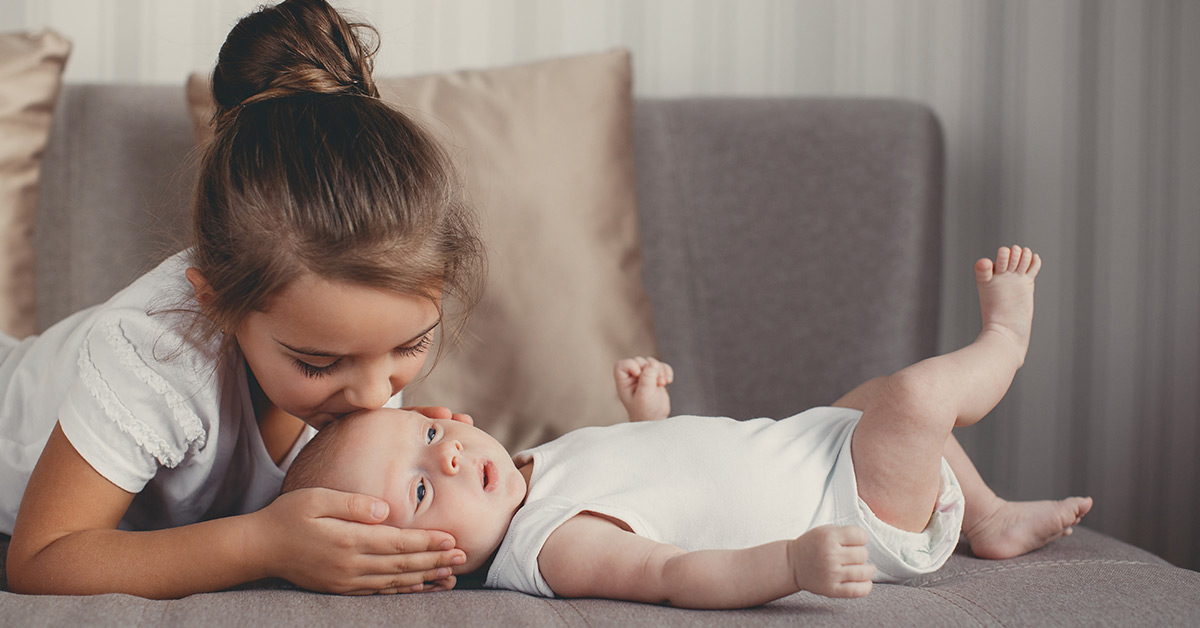 child kissing baby