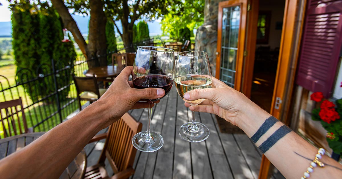 couple with glass of red and white wine in their hands