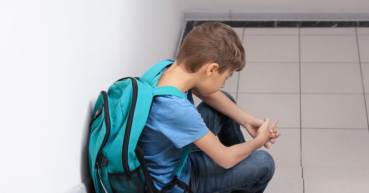 child with backpack on