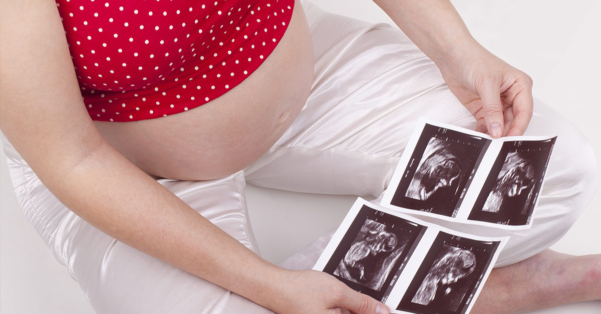 pregnant woman looking at ultrasounds