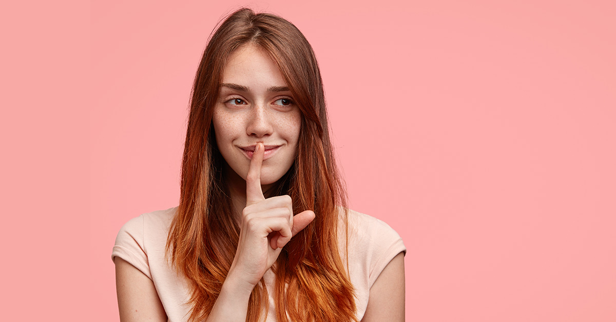 woman with finger to her lips