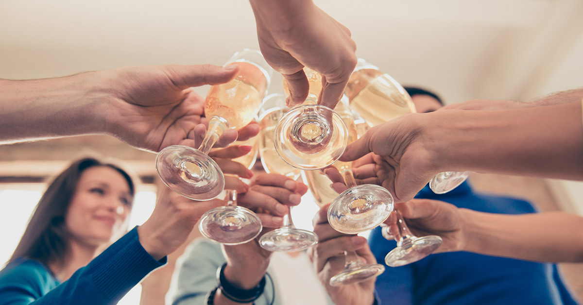people cheering wine glasses