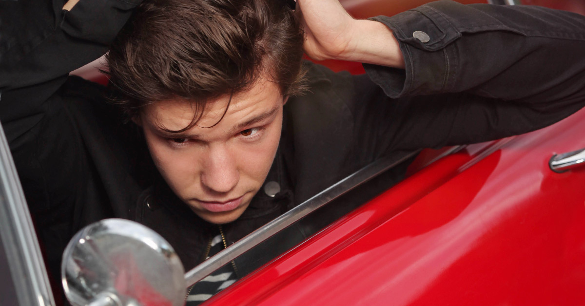 boy in red car