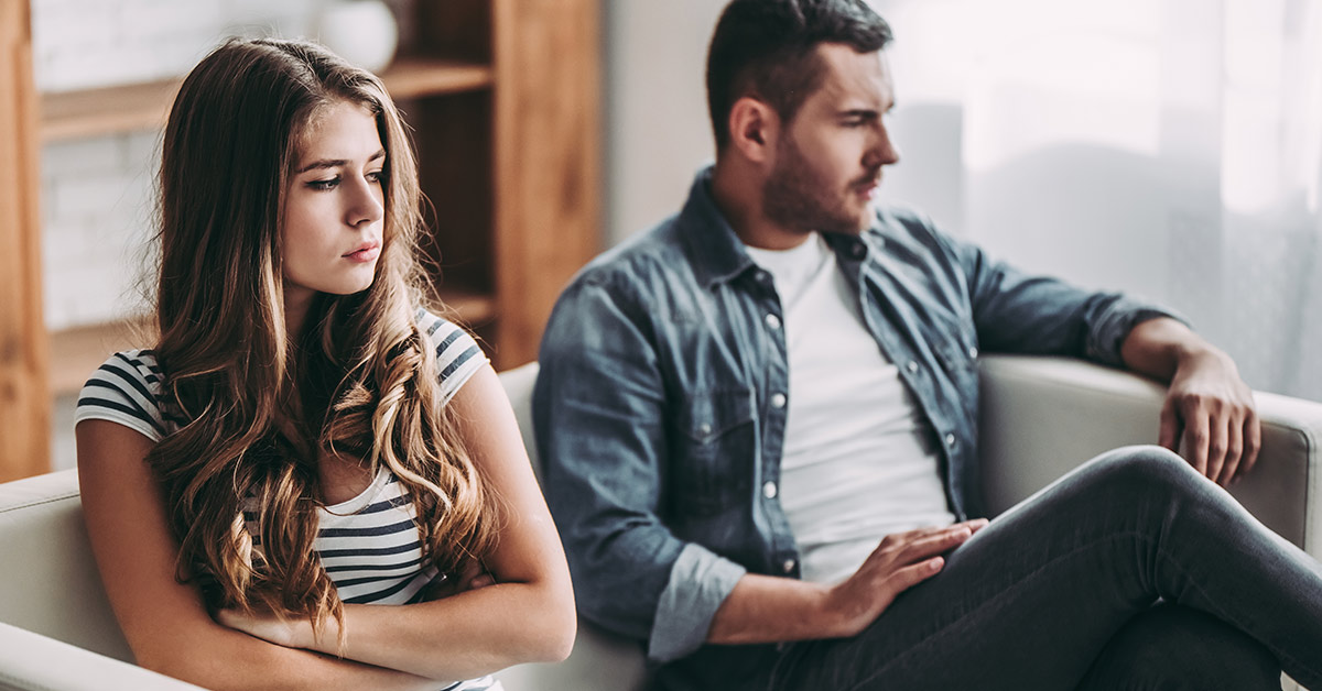 couple angry at each other sitting on the couch