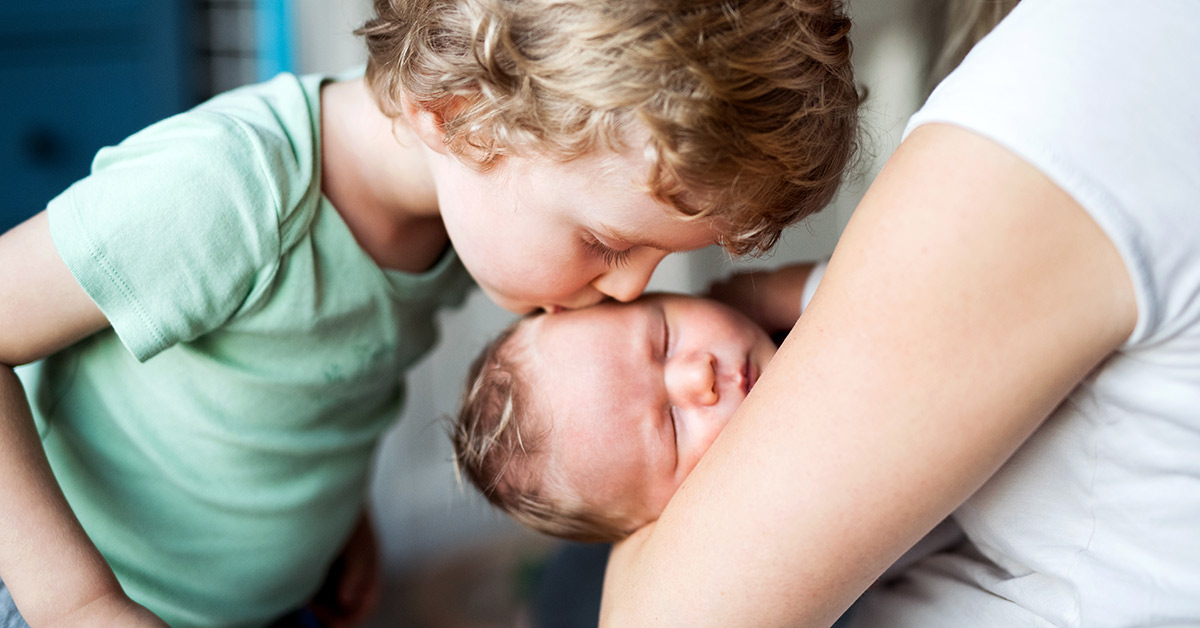boy kissing baby