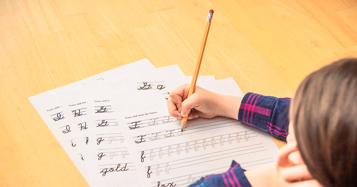 child writing cursive
