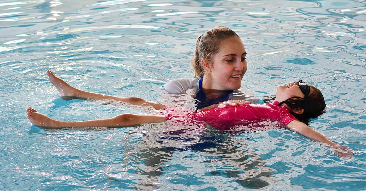 woman in swimming pool with daughter