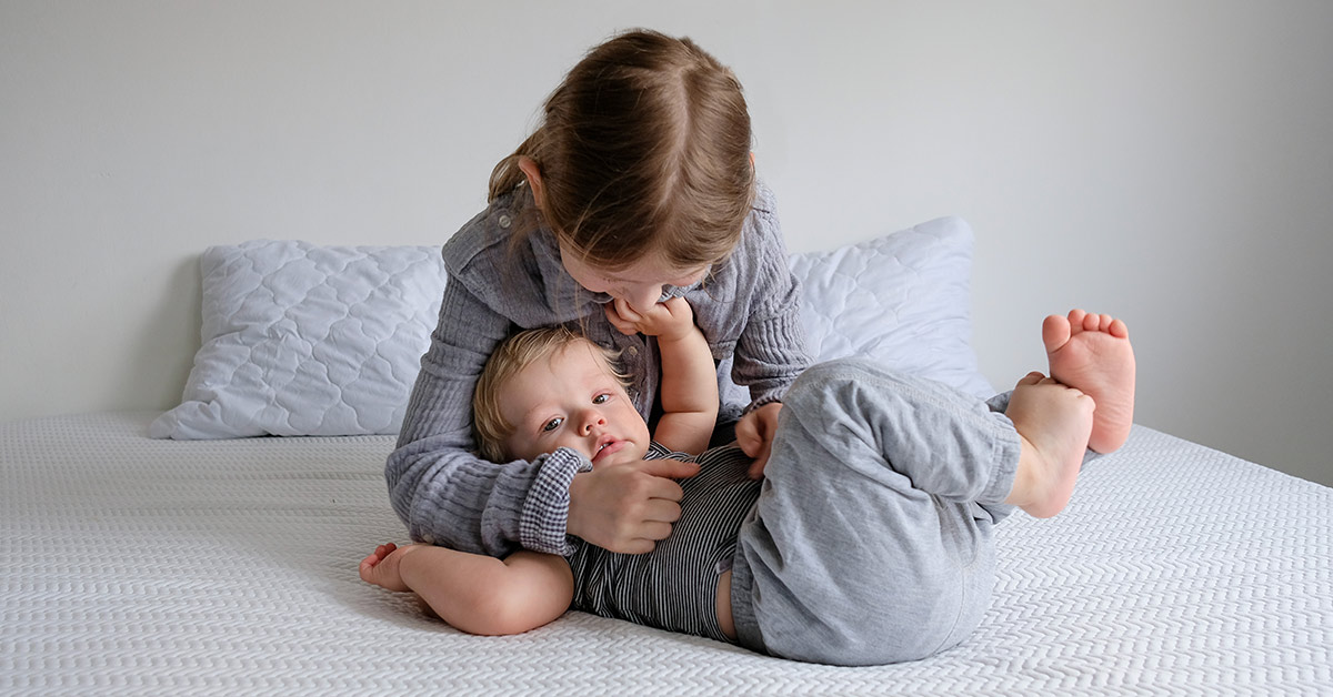 elder child playing with younger sibling