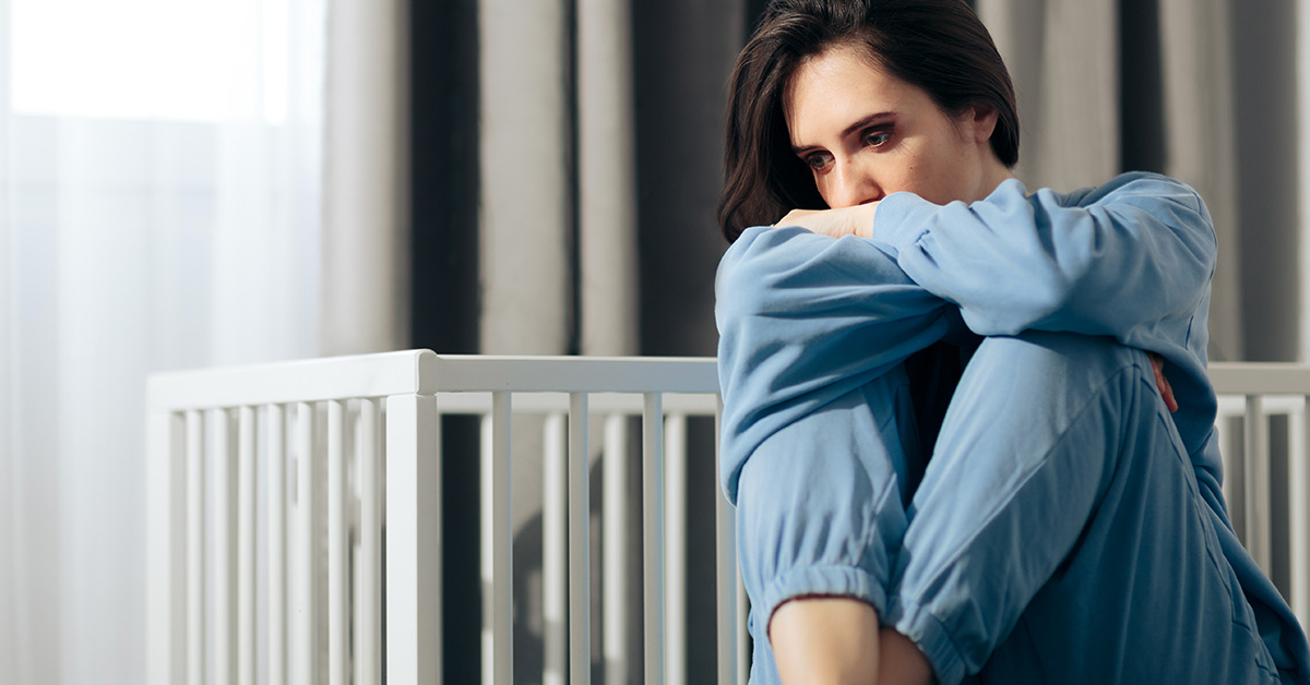 sad woman in blue outfit