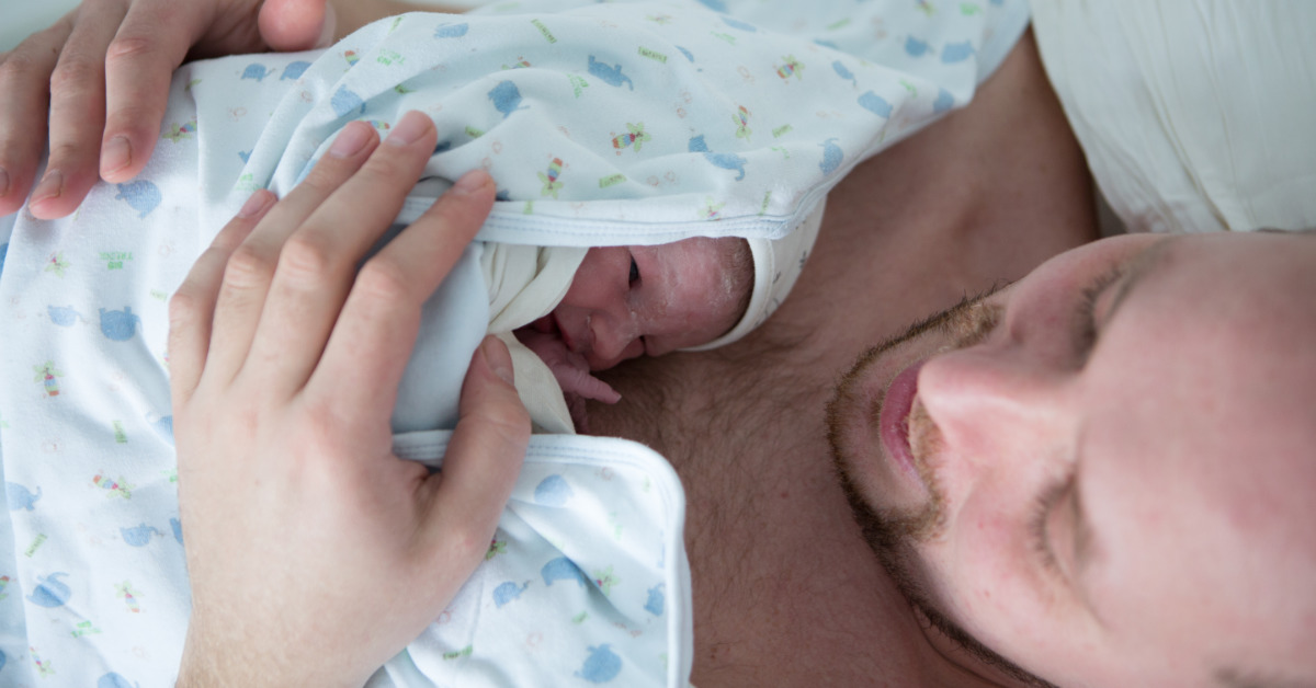 father holding infant