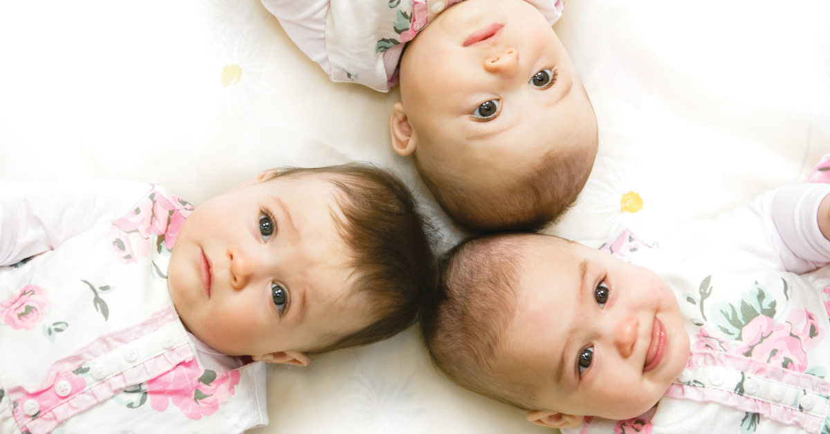 triplet babies laying head to head