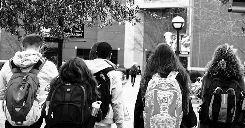 black and white photo of young teens wearing school attire