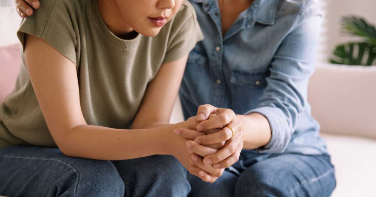 woman consoling another woman