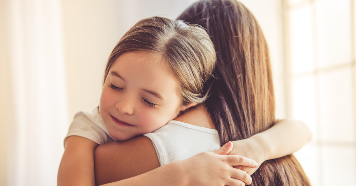 mother hugging daughter