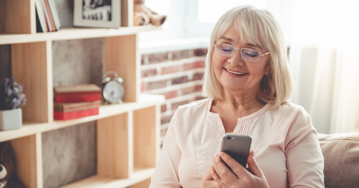 elderly woman looking at her smart phone