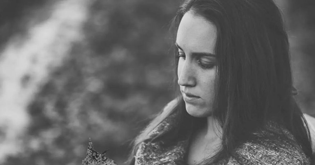 black and white image of a sad woman