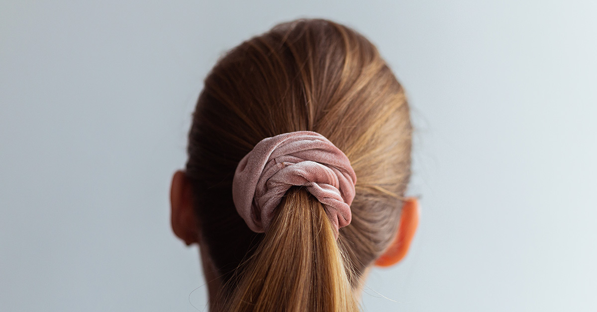 back of womans head. Hair is in a ponytail