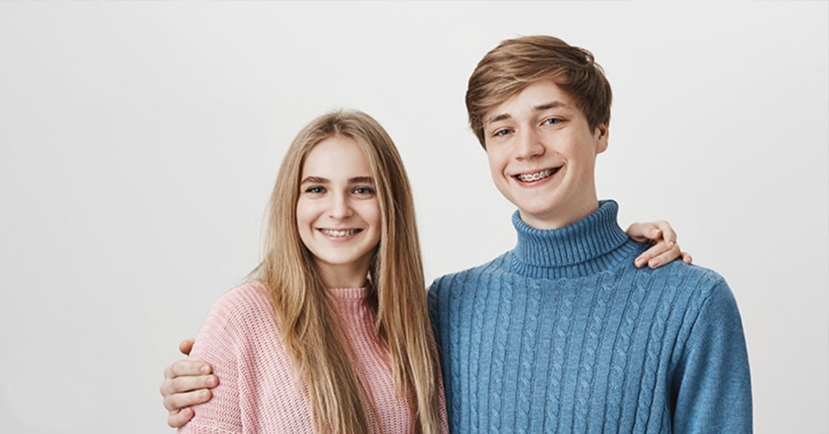 brother and sister smiling