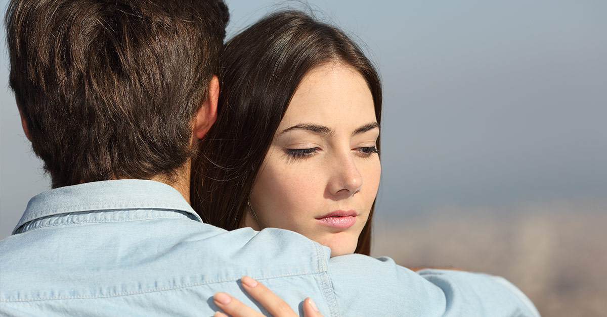 sad woman embracing a man