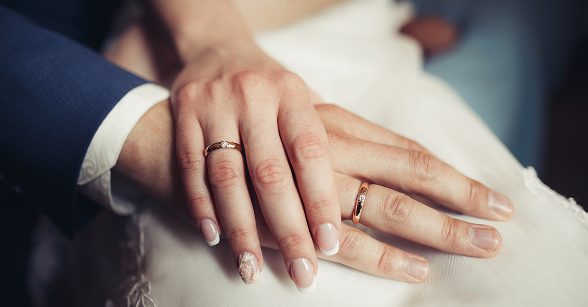 couple wearing wedding bands