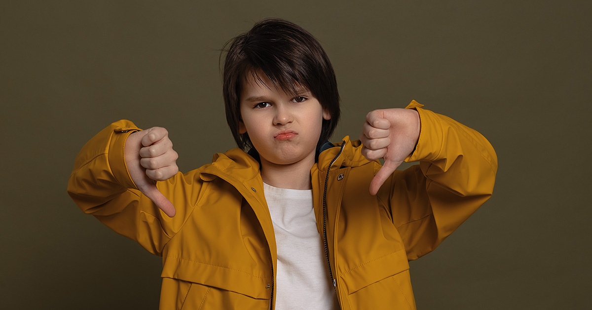 young tween boy giving thumbs down