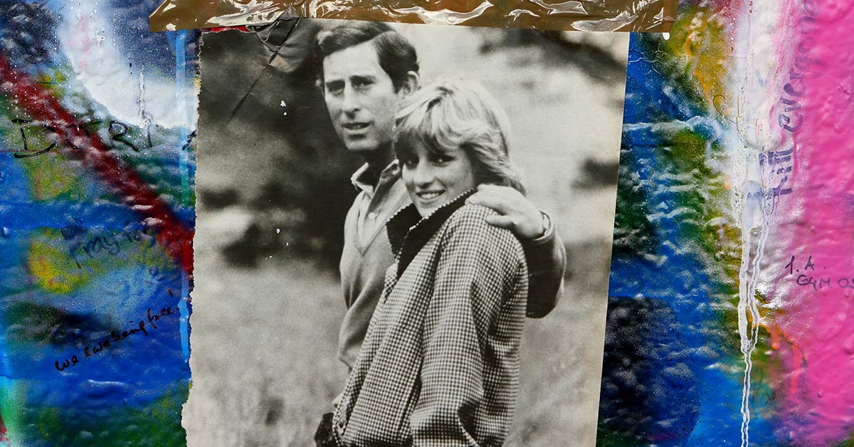 Photo of Princess Diana and Prince Charles taped to a graffiti covered wall