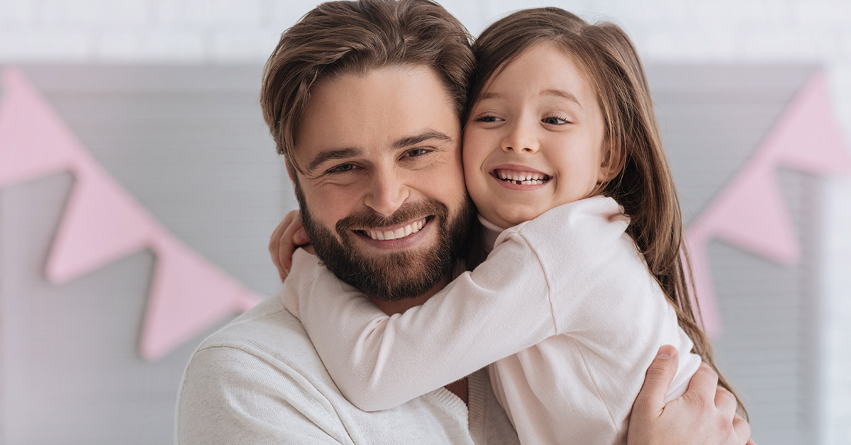 father holding his daughter