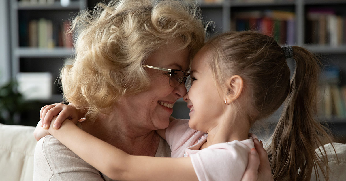 grandmother embracing grand daughter