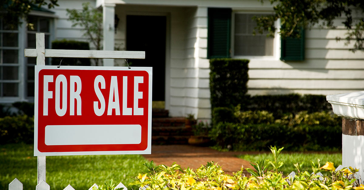 for sale sign in the front yard of a home