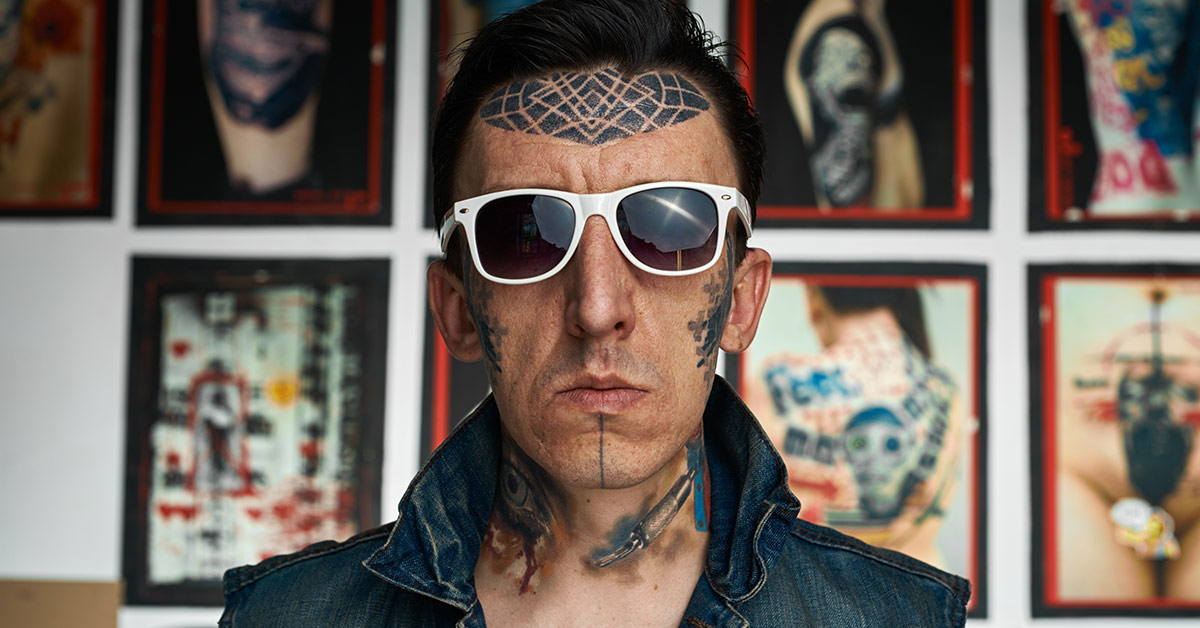 man with white sunglasses and tattoos