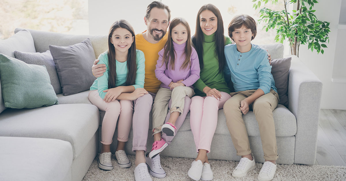 family of five sitting on a couch