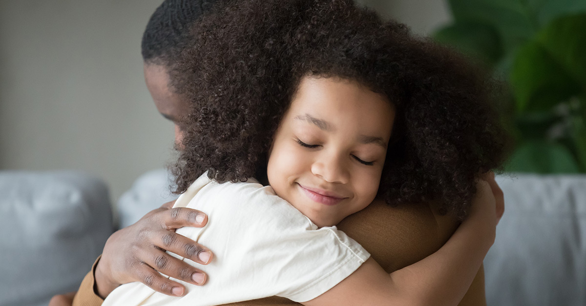 father embracing daughter