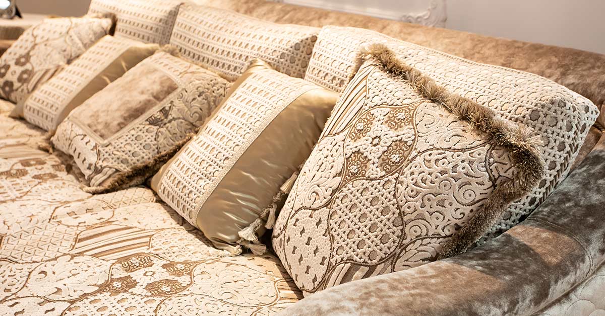 a cream coloured couch with light brown designs throughout