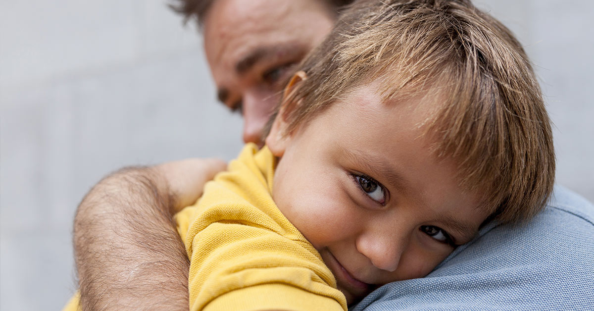 father holding adoptive son