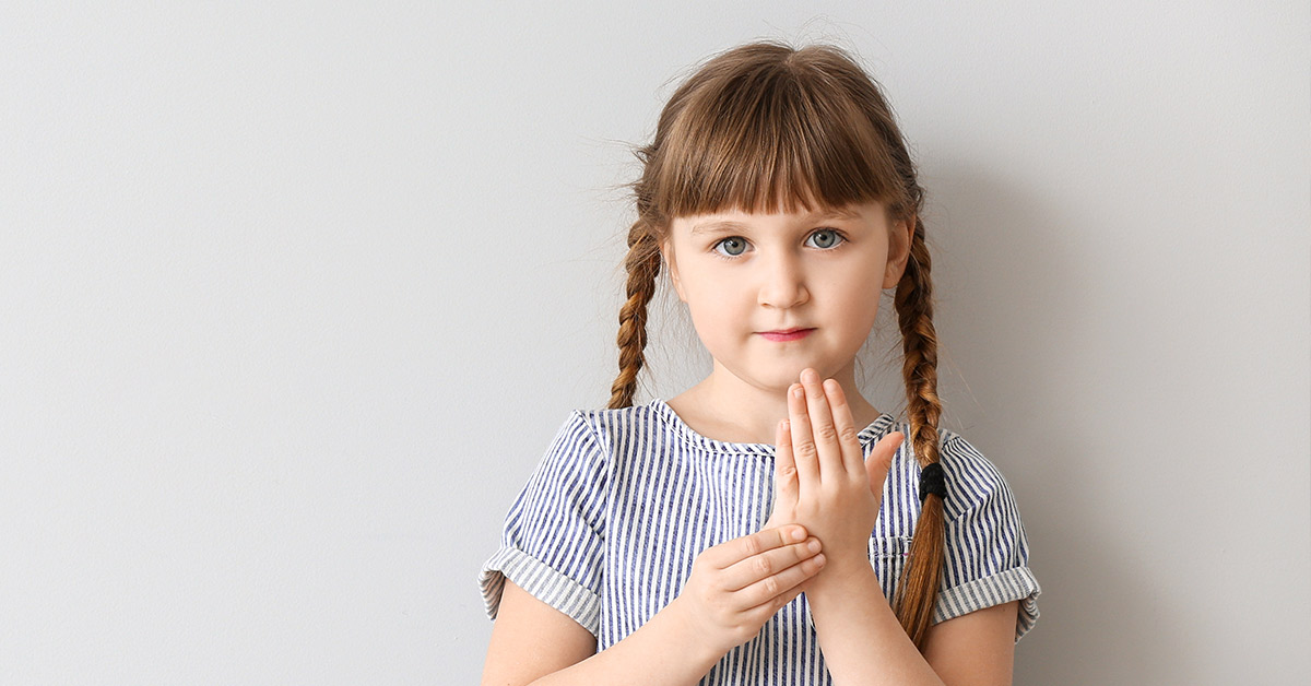 young girl with pigtails and pinstripe shirt
