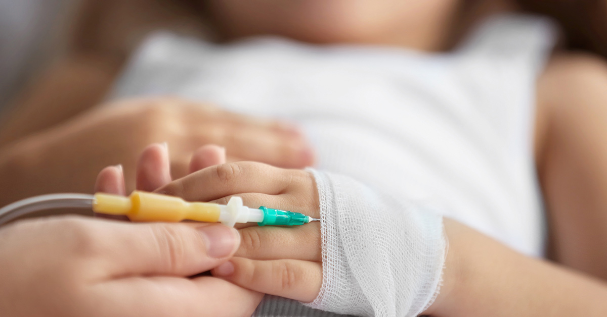 a child's hand with an IV inserted.