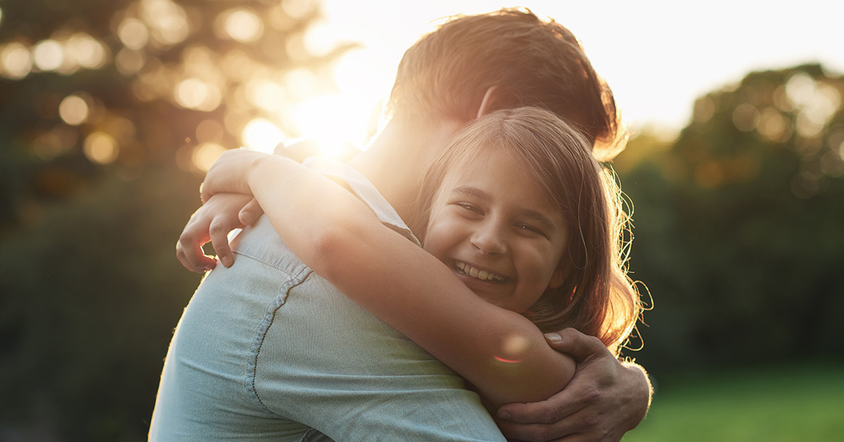 father hugging daughter