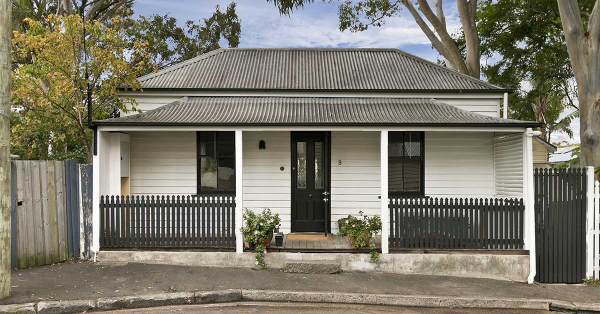 outside of an old white bungalow family home
