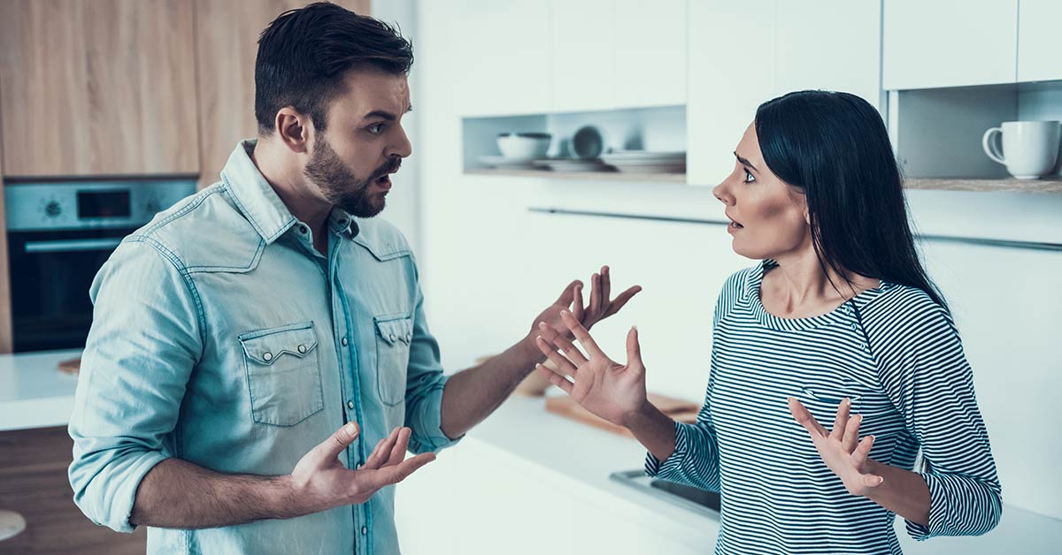 husband and wife arguing in kitchen