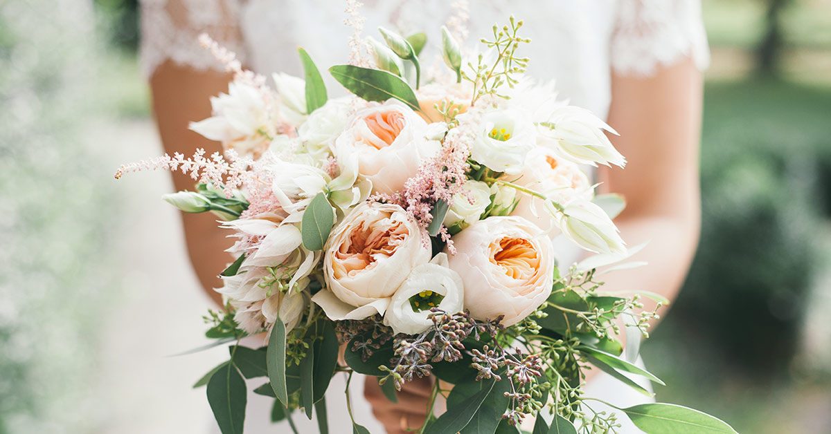 someone holding a wedding bouquet