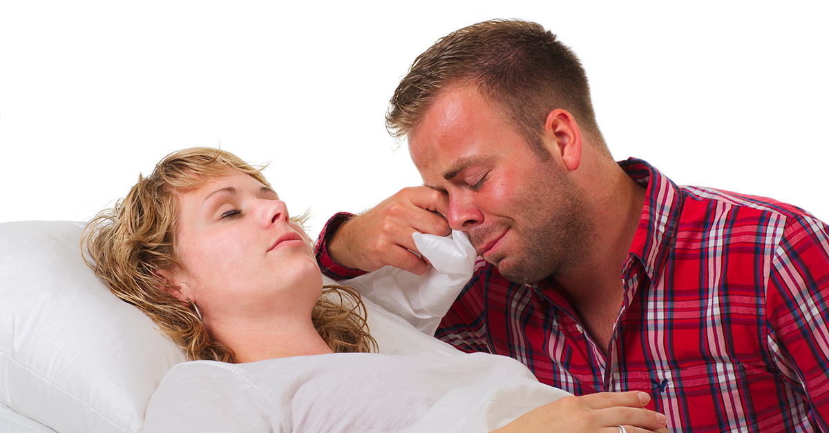 sick woman on her death bed and a crying partner