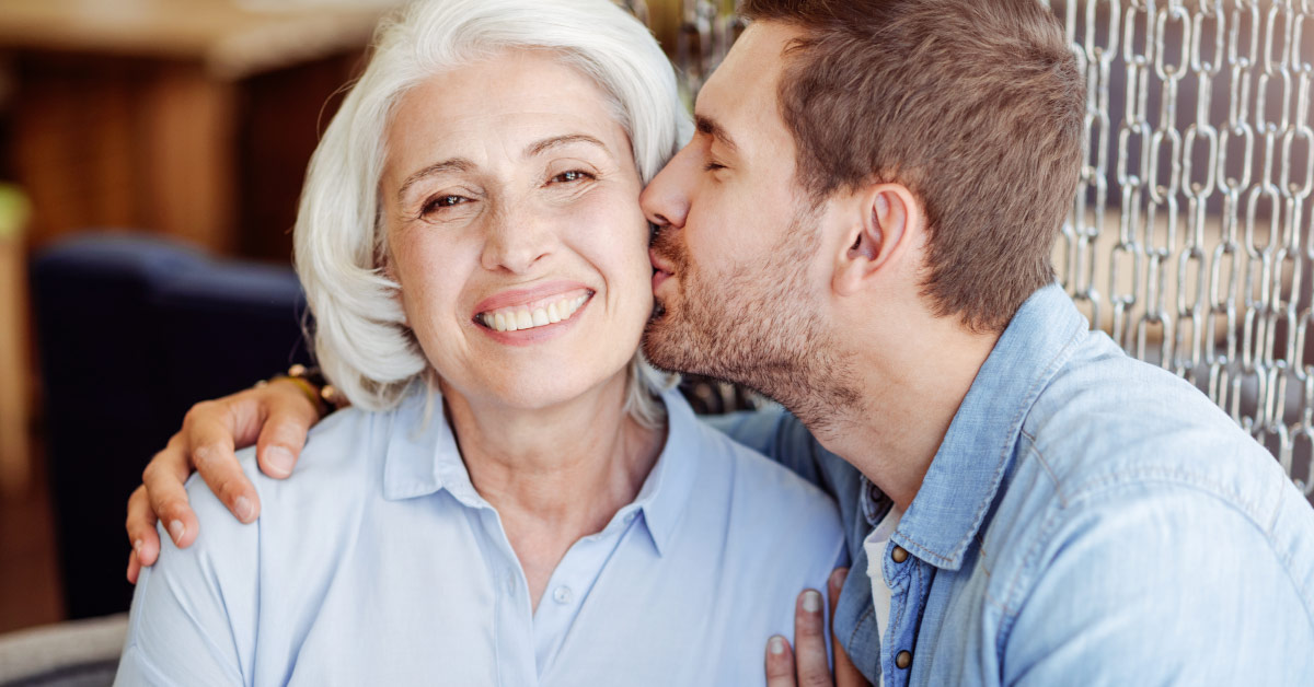grandson kissing grandmother