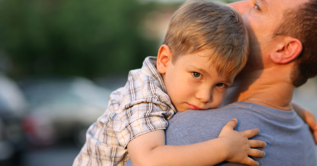 boy hugging father