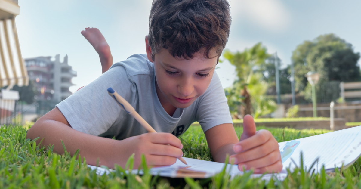 boy studying at park