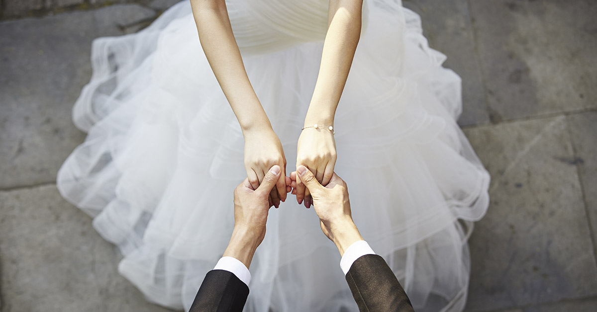 bride and groom holding hands