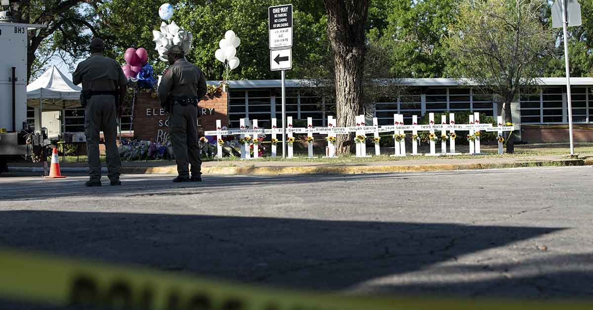 Tribute white crosses at Robb Elementary School in Uvalde Texas