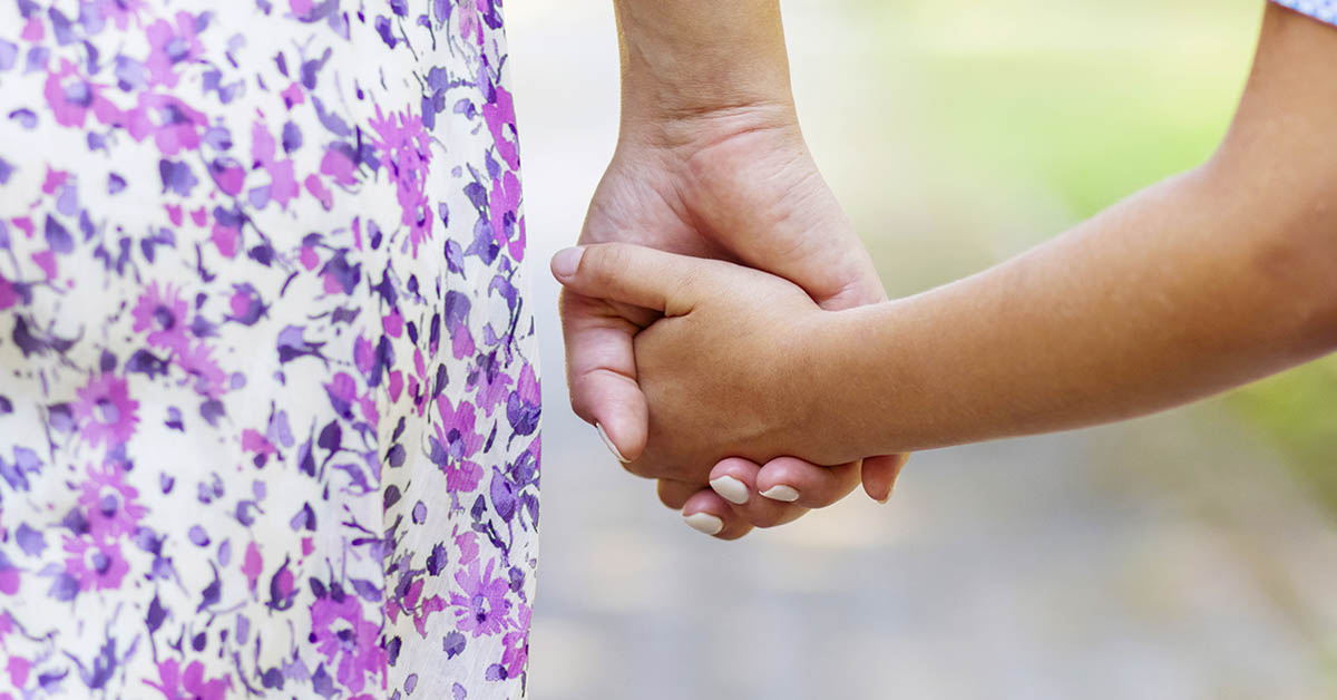 mother holding childs hand