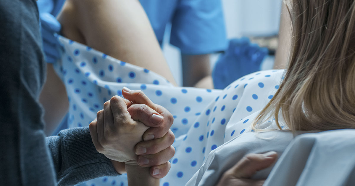 woman giving birth in hospital setting