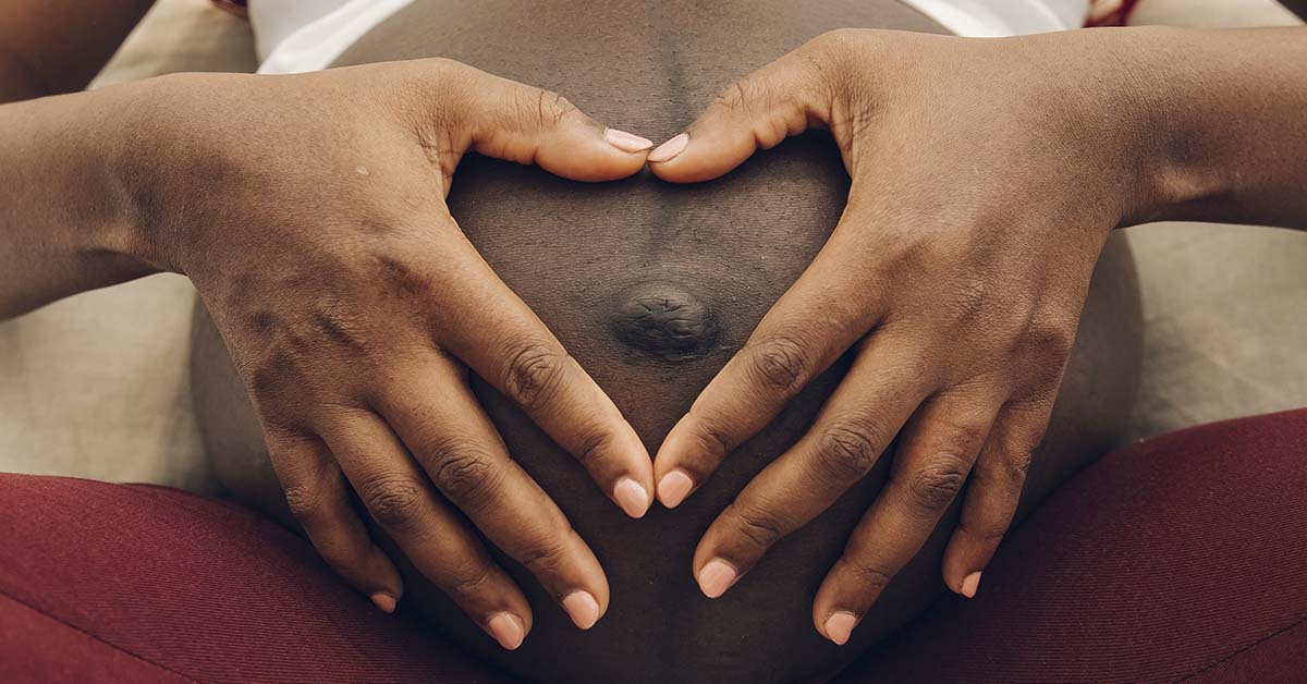 person holding pregnant belly